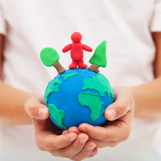 Child holding clay earth model