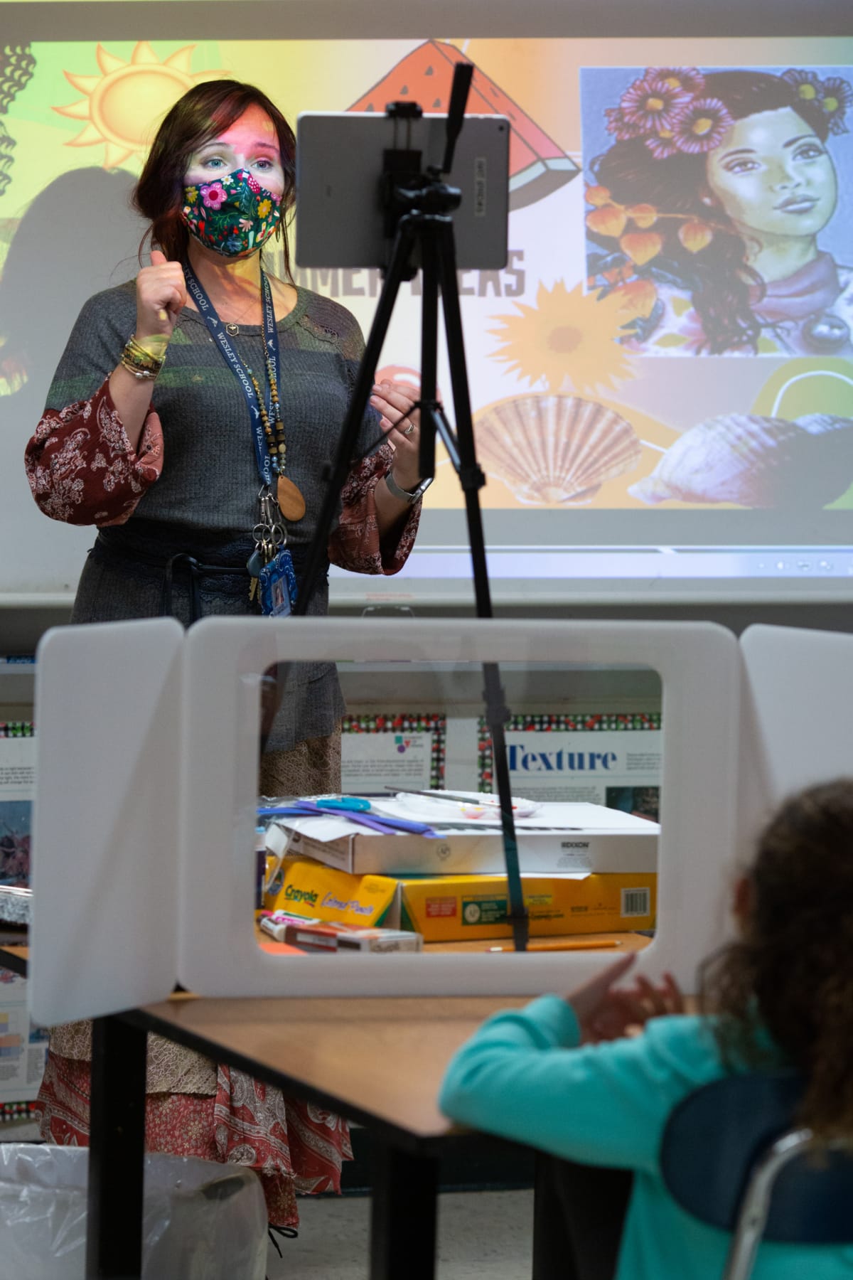 An elementary art teacher instructs second-grade students attending in person and remotely at Wesley Elementary School. <br /><strong> Photo by Allison Shelley for American Education: Images of Teachers and Students in Action