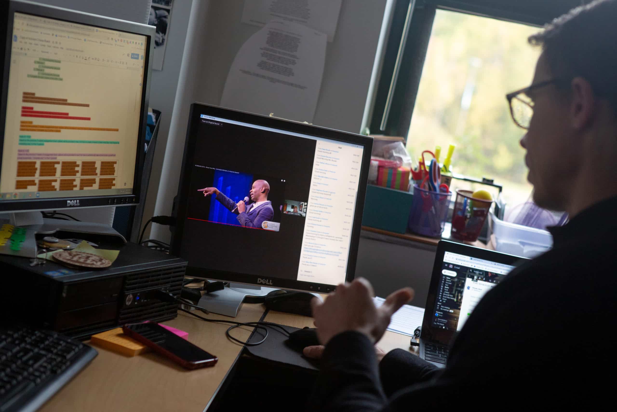 A social studies teacher participates in an online staff meeting alone in his classroom at Middletown High School.