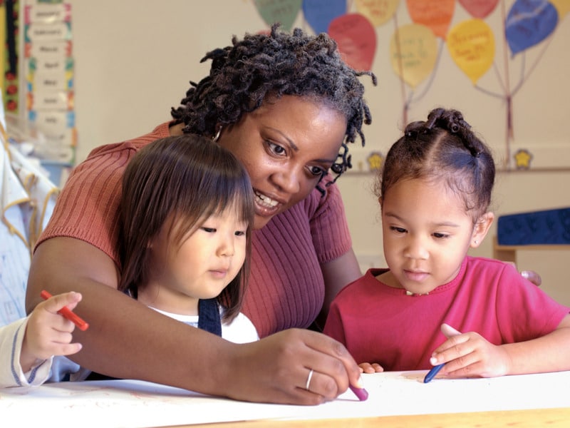 preschool teacher with two students