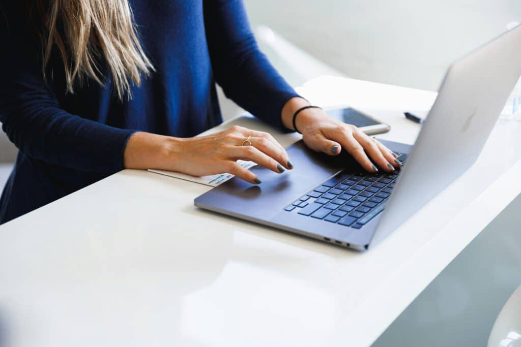 person typing on laptop